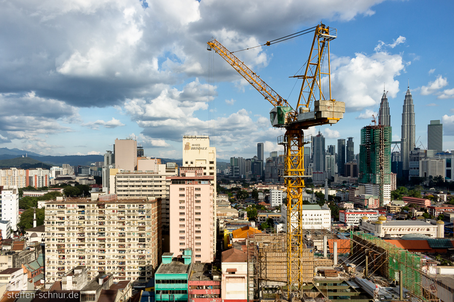 Kuala Lumpur
 Malaysia
 building lot
 crane
 close Up
 city
 clouds
