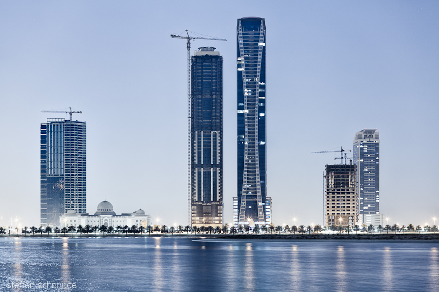 Sharjah
 building lot
 skyscrapers
 crane
 mosque
 UAE
 blue

