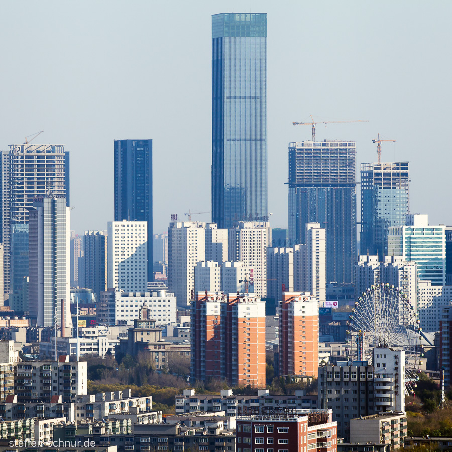 city skyline
 big wheel
 Shenyang
 China
 construction site
 metropolis
 skyscrapers
