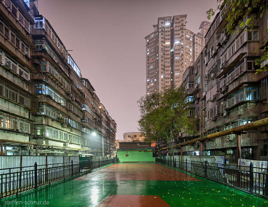 sports ground
 Tianjin
 China
 high rise
 row of houses
 night
 wet

