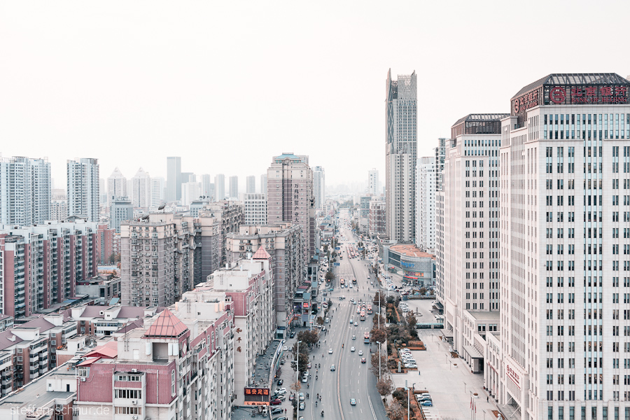 cars
 Tianjin
 China
 bank
 buses
 pedestrian
 high rise
