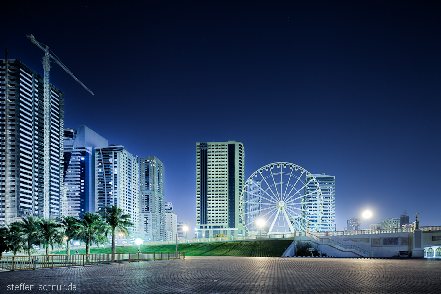 big wheel
 Sharjah
 architecture
 building lot
 Trees
 crane
 UAE
